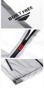 Detail of white and grey jacket with BUILT FREE text and red U-shaped zipper pull