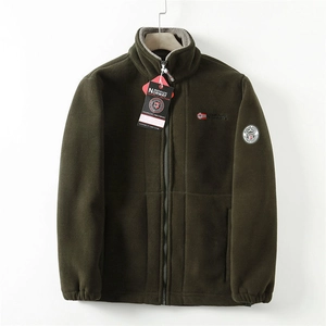 Detailed view of dark green fleece jacket featuring Norway embroidery and sleeve patch