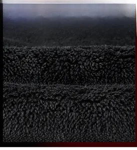 Macro view of premium black fleece fabric showing the thick anti-pilling texture
