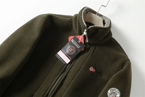 Detail of warm olive green fleece jacket with Norway embroidery and stand-up collar