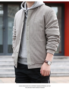 Detailed view of men's grey waffle texture jacket with buttons and ribbed cuffs for casual wear