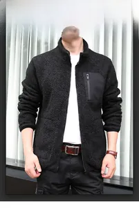 Detail of black fleece jacket showing high-density texture and zippered chest pocket