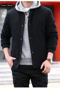 Detailed waffle texture of black men's outdoor jacket with metal buttons and ribbed cuffs