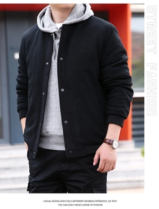 Detail of waffle textured men's jacket featuring black metal snap buttons and ribbed cuffs