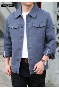 Detail der jeansblauen Jacke mit Berg-Aufnäher am Ärmel und metallischer Knopffläche