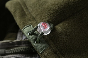 Detail of army green fleece jacket with spherical toggle and GN drawstring cord