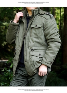 Outdoor shot of men's military green hooded jacket with utility pockets and shoulder straps