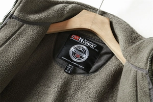 Detail of army green fleece jacket collar with size tag on a wooden hanger