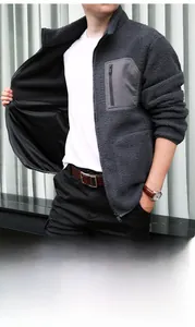 Detail of men's gray polar fleece jacket featuring chest zip pocket and smooth lining