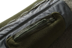 Detailed close-up of tactical fleece jacket arm pocket with grey mesh lining and zipper