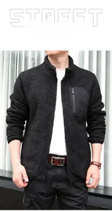 Detail view of black fleece jacket showing stand collar and contrast zipper chest pocket