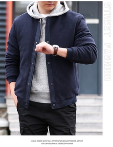 Close-up of navy waffle knit jacket with snap buttons and street fashion details