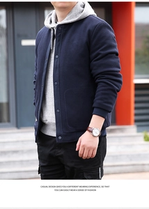Detail of waffle knit fabric and snap button closure on navy blue men's jacket
