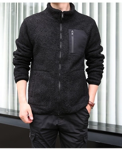 Detail of men's black fleece jacket featuring a stand collar and a contrast chest pocket