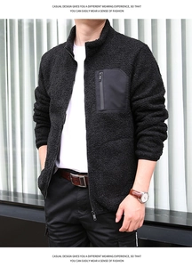 Detail of black fleece jacket featuring a contrasting zippered chest pocket and stand collar