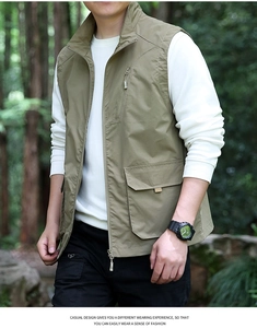 Detail of olive green outdoor utility vest with zip pockets and stand collar