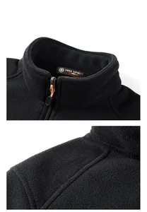 Detail view of black fleece jacket showing metal zipper and Free Spirit collar label