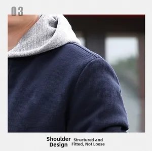 Detailed view of structured shoulder design on blue waffle knit jacket with gray hood