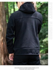 Rear view of men's black fleece hooded jacket with decorative stitching in outdoor setting