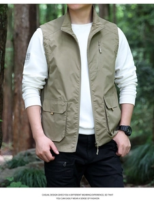 Outdoor lifestyle shot of khaki green multi-pocket utility vest with stand collar