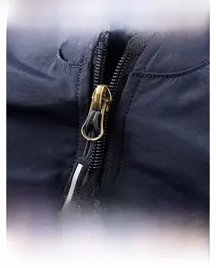 Close-up of premium metal zipper and windproof placket on men's outdoor jacket