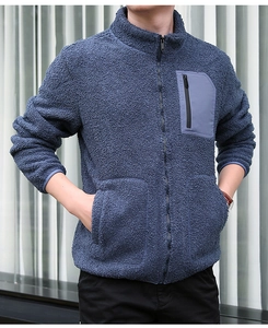 Detail view of polar fleece jacket with stand-up collar and blue chest zip pocket