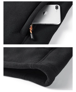 Detail of fleece jacket zipper pocket with phone and stitching on black polar fleece fabric