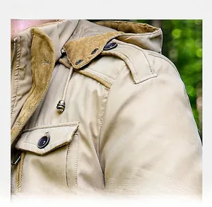 Detail view of khaki jacket showing corduroy collar and buttoned shoulder epaulette strap