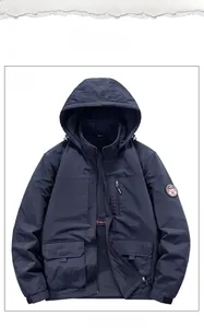 Detailed flat lay of dark blue windbreaker with drawstring hood and outdoor patch
