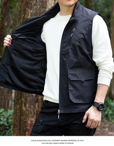 Detail of black utility vest showing breathable mesh lining and zippered tactical pockets