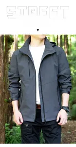 Detail view of water-resistant outdoor jacket in dark grey with functional zipper pockets