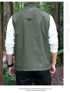 Close-up of military green outdoor vest with stand-up collar and utility stitching details