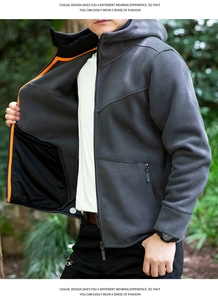 Detail view of men fleece jacket showing vibrant orange zipper trim and large inner pocket