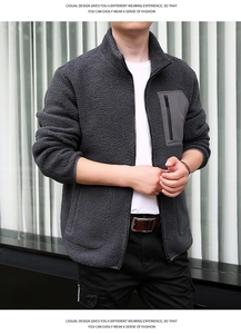 Detail of grey polar fleece jacket featuring a stand-up collar and contrast zipper pocket