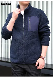 Close-up of navy blue polar fleece jacket showing zip pocket and soft texture