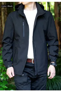 Close-up of black waterproof hooded windbreaker jacket with functional zipper pockets