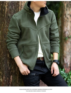 Detail of army green hooded fleece jacket with full zipper and functional zip pockets