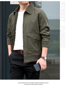 Close-up of olive green cotton flight jacket featuring tactical pockets and embroidery