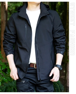 Detail of waterproof black men's hooded jacket with chest zipper pocket and velcro cuffs