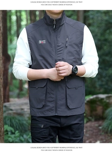 Detailed view of the zip-up cargo vest pockets and embroidered outdoor branding