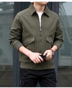 Detailed close-up of army green cotton flight jacket with ribbed cuffs and cargo pockets