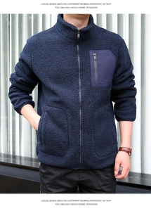 Detail of navy blue fleece jacket with high collar and zippered contrast chest pocket