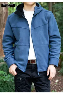 Outdoor lifestyle shot of a denim blue hooded fleece jacket with full-zip and pockets