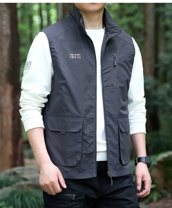 Detail of grey multi-pocket tactical vest featuring chest logo and stand collar