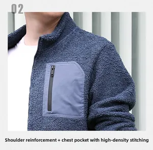 Close-up of blue fleece jacket featuring a grey zipper chest pocket and stand collar