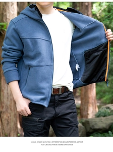 Detail of blue outdoor fleece jacket showing the hood, zipper, and textured fabric