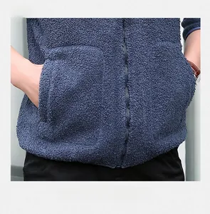Detail of navy blue polar fleece jacket showing functional side pockets and smooth zipper
