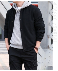 Close-up of black waffle texture fabric and metal snap buttons on men casual jacket