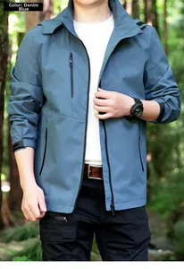 Detail of denim blue outdoor jacket featuring adjustable velcro cuffs and zippered pockets