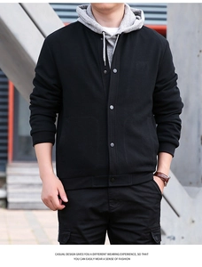 Detail of men's black waffle jacket with metallic snap buttons and a textured finish